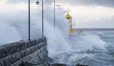 Waves crashing over Reykjavík lighthouse