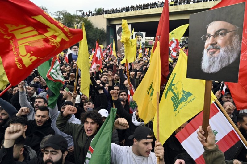 Supporters of Hezbollah shout slogans as they carry flags of Hezbollah and pictures of Hezbollah late leader Hassan Nasrallah during a protest in front of the entrance to Rafic Hariri International Airport in Beirut, Lebanon, on Saturday. Photo by Wael Hamzeh/EPA-EFE