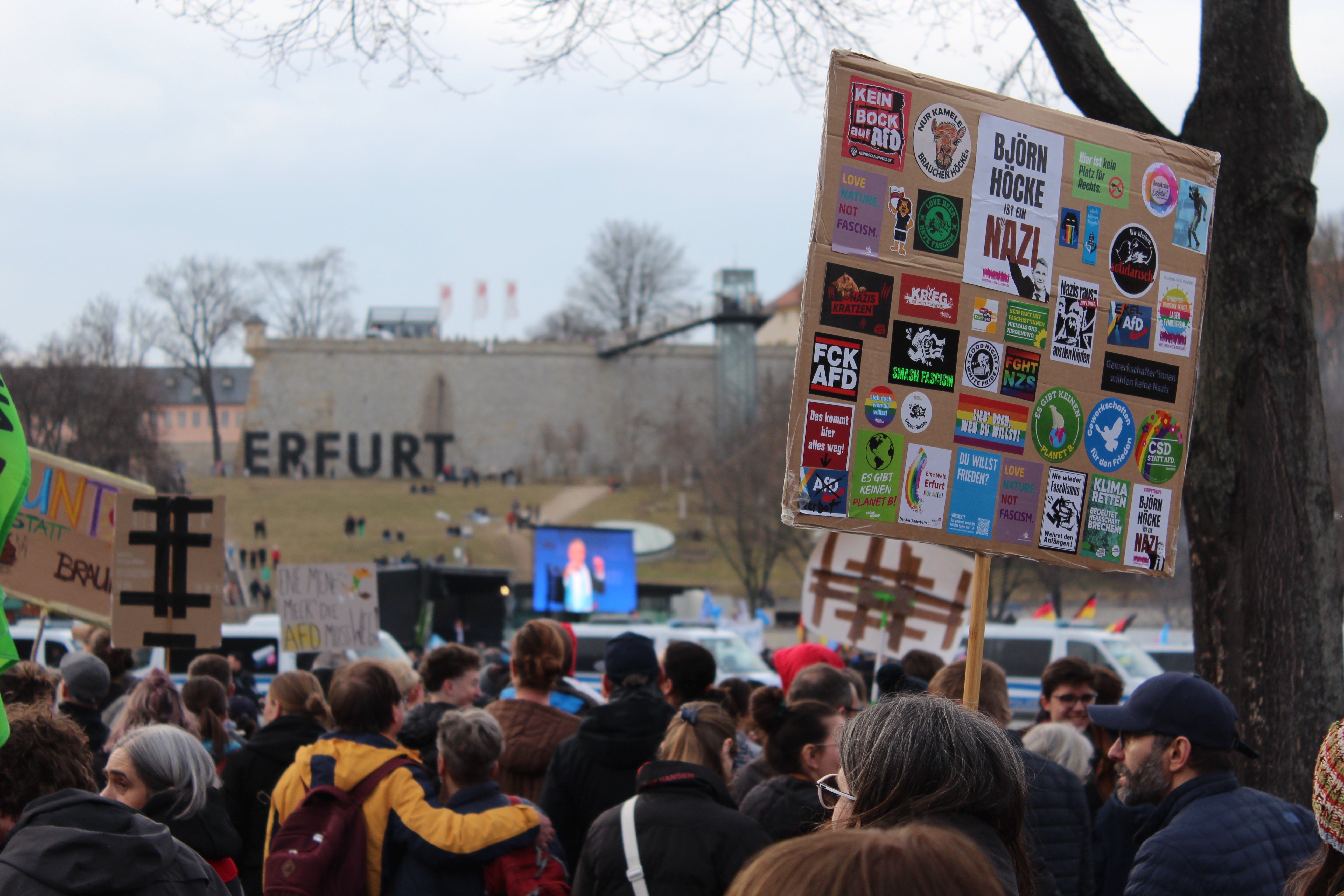 A woman holds a placard denouncing Bjorn Hocke as a Nazi in Erfurt