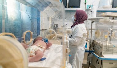 A woman in hijab heads to work as a neonatal nurse at the Al-Amal Maternity Hospital in Aleppo.