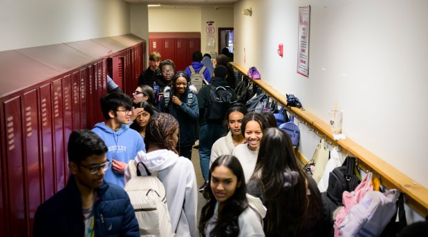 A narrow hallway full of students.