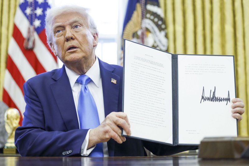 US President Donald J. Trump talks to reporters and signs a series of executive orders, including one reinstating his maximum pressure campaign on Iran, in the Oval Office of the White House in Washington, D.C., on Tuesday. Photo by Shawn Thew/UPI