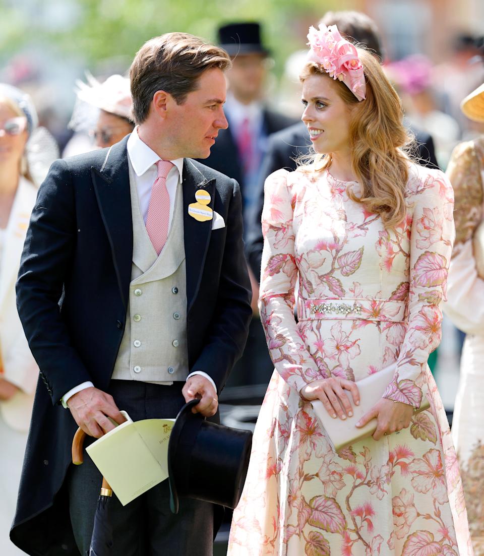 Princess Beatrice wearing a white dress with pink flowers smiling and turning to Edoardo Mapelli Mozzi, wearing a morning suit at Royal Ascot