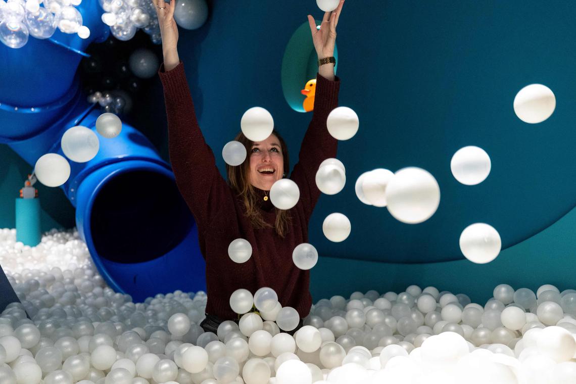 Museum founder Andrea Golubic poses inside a pool full of small white balls at the HaHaHouse museum of laughter in central Zagreb, on January 21, 2025. The 450-square-metre (4,844-square-feet) museum, which opened in January, offers eight interactive zones and has also an educational part featuring the history of humour from ancient to modern times and via different formats -- theatre, film or Internet. (Photo by Damir SENCAR / AFP)