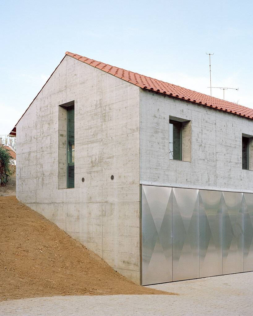 arquitectura-G combines concrete garage with residence beneath tiled roof in portugal