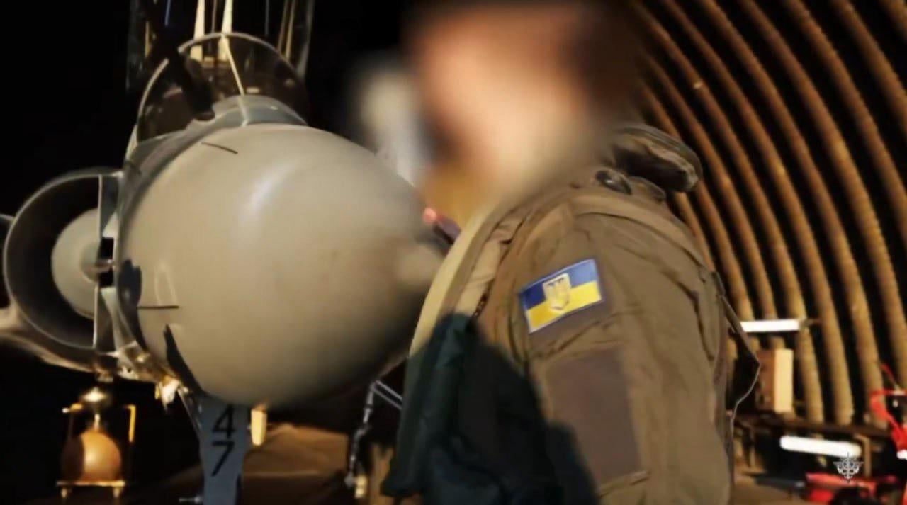 A pilot from the Ukrainian Air Force and his French-supplied Dassault Mirage 2000-5F multirole fighter jet, in a hanger.