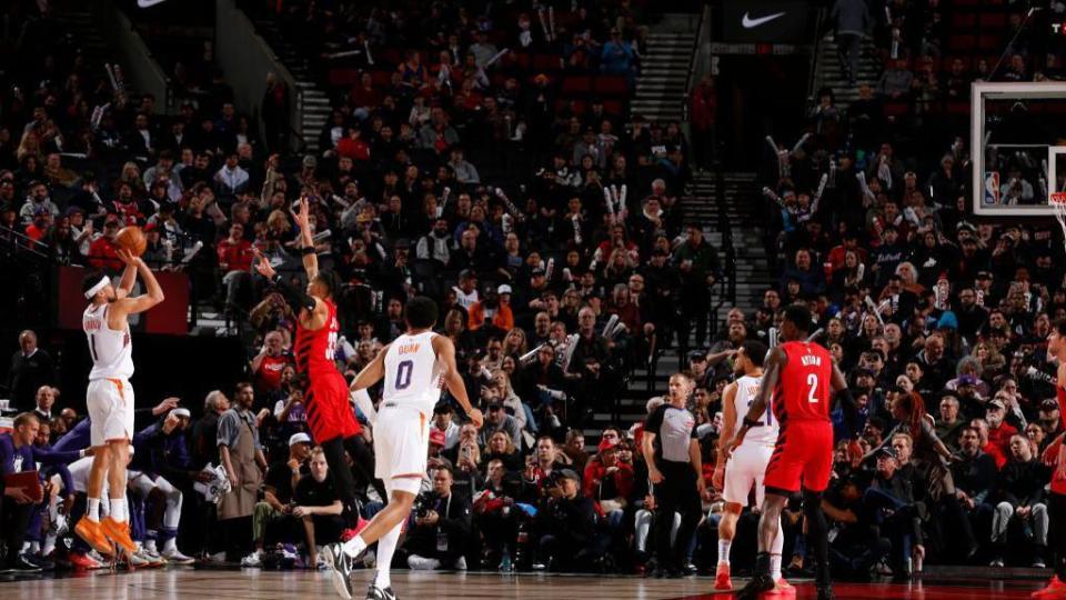 Devin Booker preparing to throw his three-pointer than broke the Phoenix Suns' scoring record.