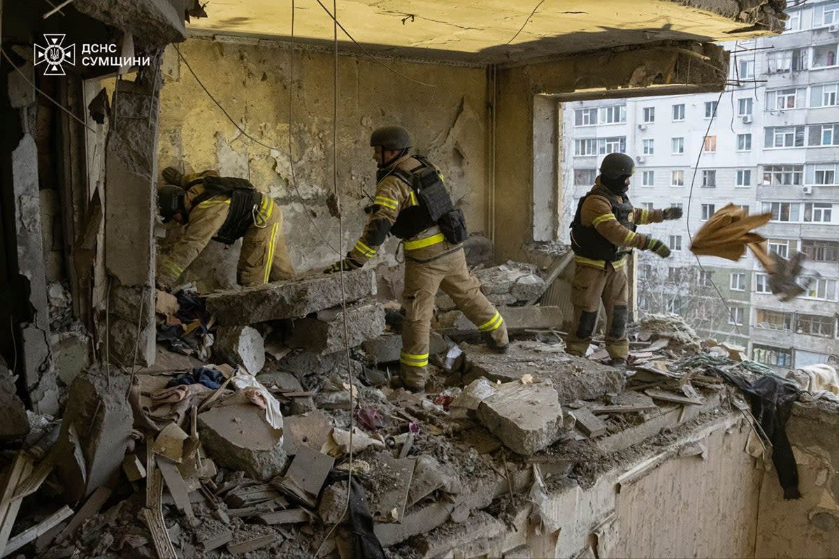 Rescuers search for civilians who were killed when a Russian drone hit an apartment building in Sumy, Ukraine (Ukrainian Emergency Service via AP)