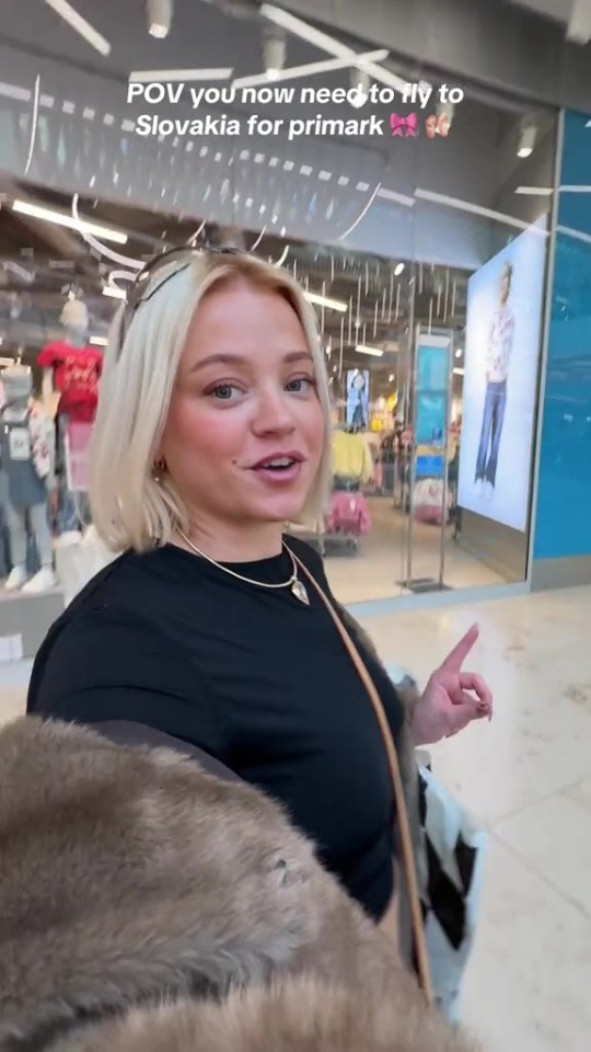 Woman in a fur coat shopping in a Primark store.