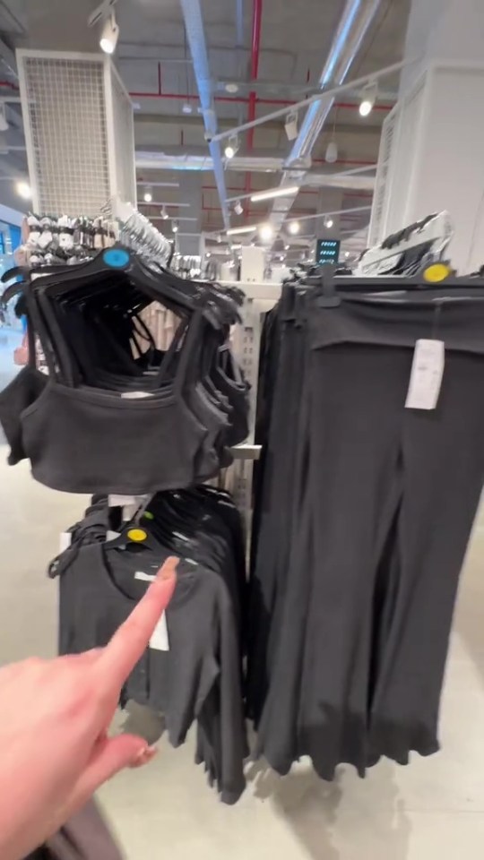 Black crop tops and pants on display in a Primark store.