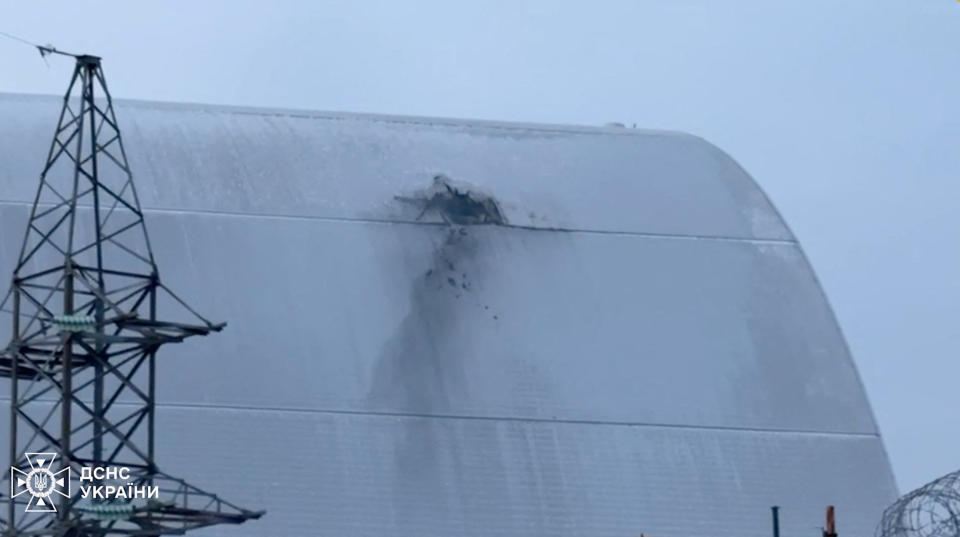 The structure that covers the old sarcophagus which confines the remains of the damaged fourth reactor of the Chornobyl Nuclear Power Plant, bears an impact of what the Ukrainian President Volodymyr Zelenskiy says was a Russian drone strike, amid Russia's attack on Ukraine, at Chornobyl, in Kyiv region, Ukraine February 14, 2025 in this screengrab taken from a handout video. Ukrainian Presidential Press Service/Handout via REUTERS
