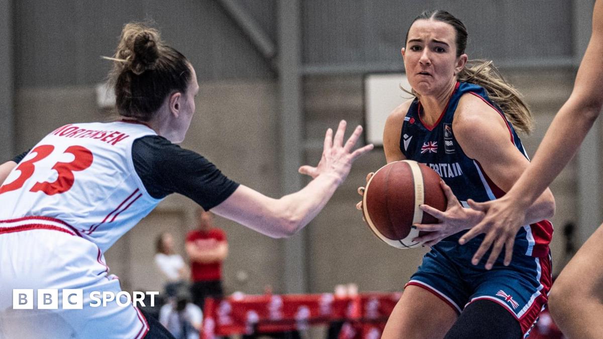 A GB player holds the basketball during the game against Denmark