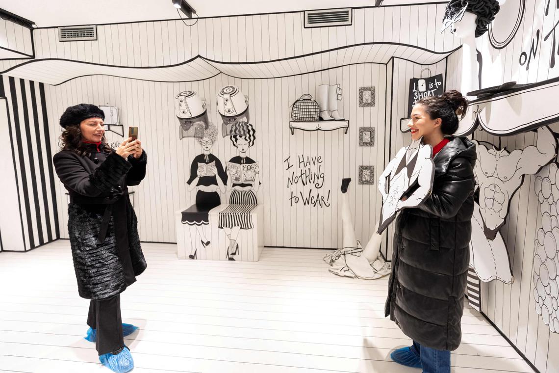 Visitors pose for pictures in a room at the HaHaHouse museum of laughter in central Zagreb, on January 21, 2025. The 450-square-metre (4,844-square-feet) museum, which opened in January, offers eight interactive zones and has also an educational part featuring the history of humour from ancient to modern times and via different formats -- theatre, film or Internet. (Photo by Damir SENCAR / AFP)
