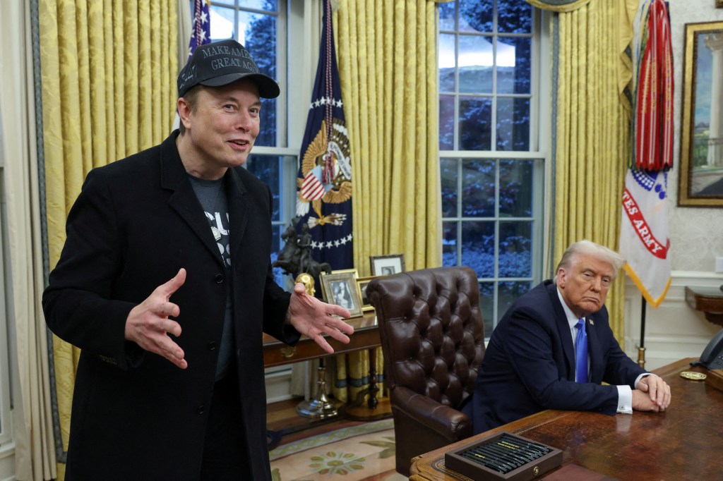 Elon Musk and President Donald Trump speak to the press inside the Oval Office of the White House on Feb. 11, 2025.