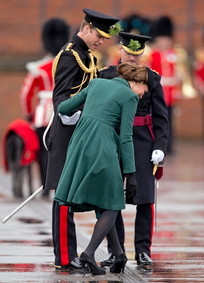 Prince William assisting Catherine, Duchess of Cambridge, whose shoe heel is stuck in a grate.