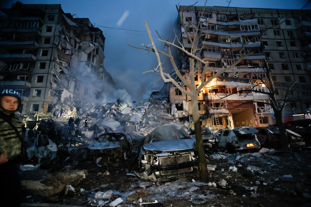 Emergency workers clear the rubble after a Russian rocket hit a multistory building leaving many people under debris in Dnipro, Ukraine, Saturday, Jan. 14, 2023.