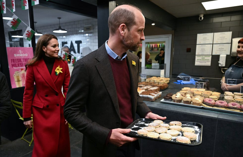 pontypridd, wales february 26: prince william, prince of wales and catherine, princess of wales distribute to well wishers the welsh cakes made by themselves, during a visit to pontypridd market on february 26, 2025 in pontypridd, wales. in december 2024, pontypridd was one of a number of towns across wales which was hit by severe flooding as a result of storm bert and storm darragh. the prince and princess met with local residents, learning about their experiences and the impact of recent events in the town. (photo by ben stansall wpa pool/getty images)