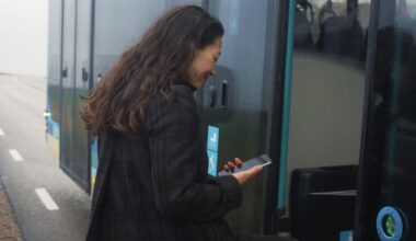 Woman boarding  Hallandstrafiken and using PAYG app for ticketing