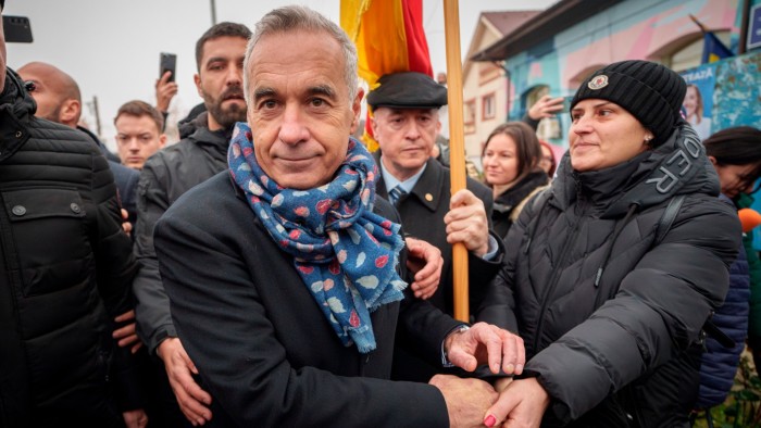 Călin Georgescu walks through a crown of supporters