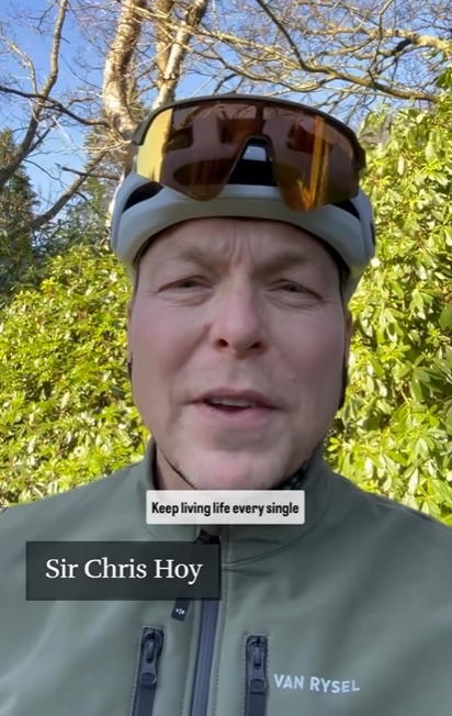Sir Chris Hoy wearing a cycling helmet and jacket.