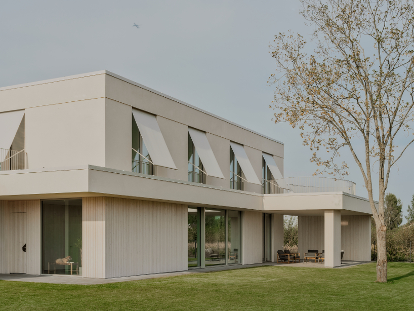 GAISS rests house's linear symmetrical volume on timber-clad plinth in latvia