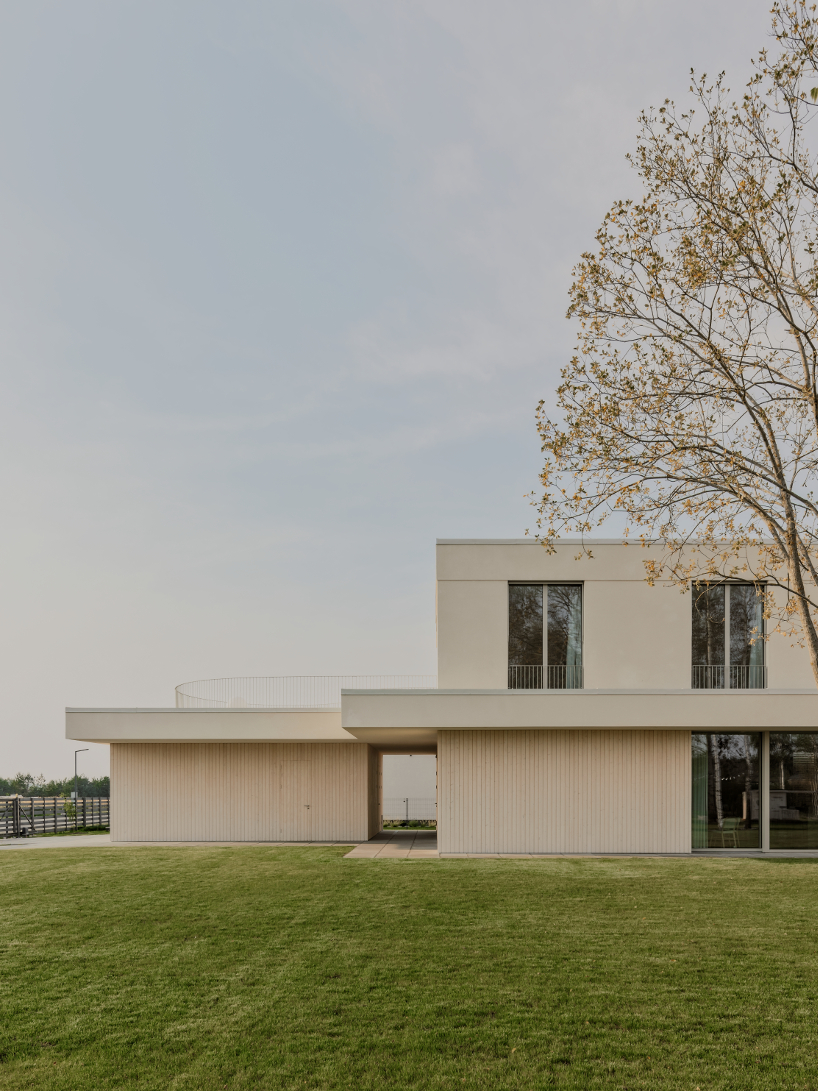 GAISS rests house's linear symmetrical volume on timber-clad plinth in latvia