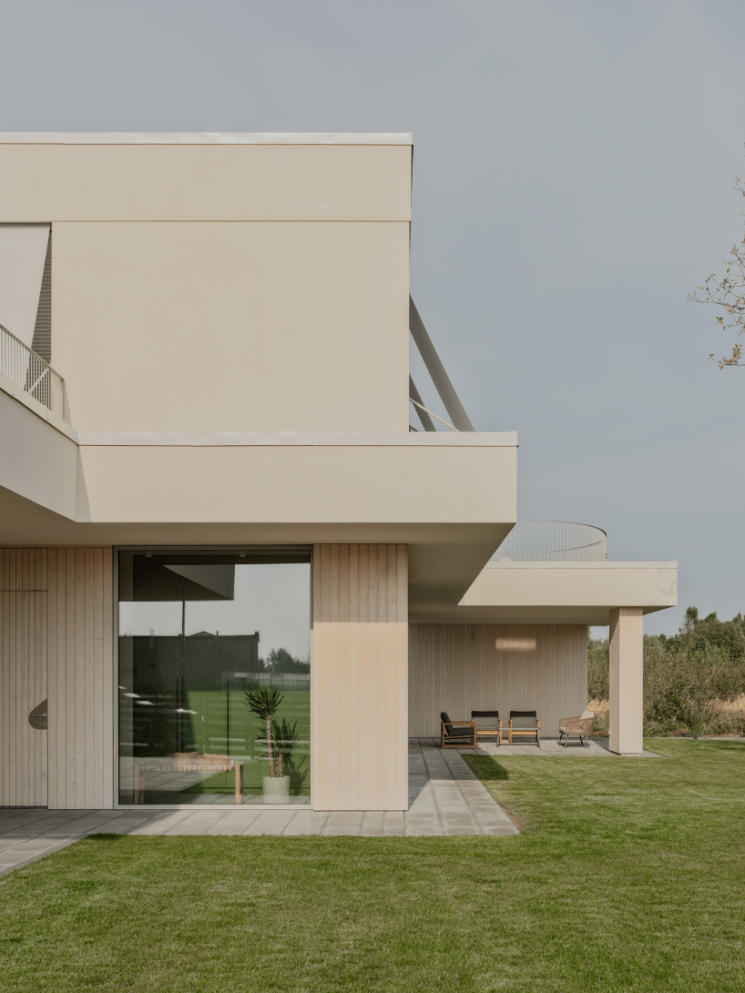 GAISS rests house's linear symmetrical volume on timber-clad plinth in latvia