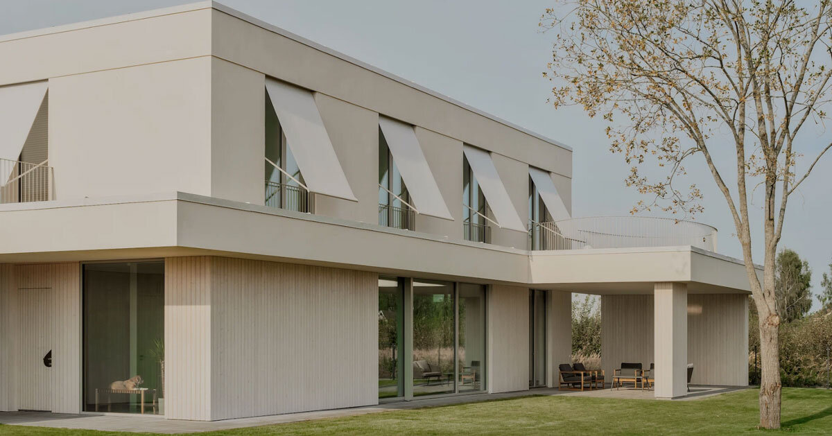 GAISS rests house's linear volume on timber-clad plinth in latvia