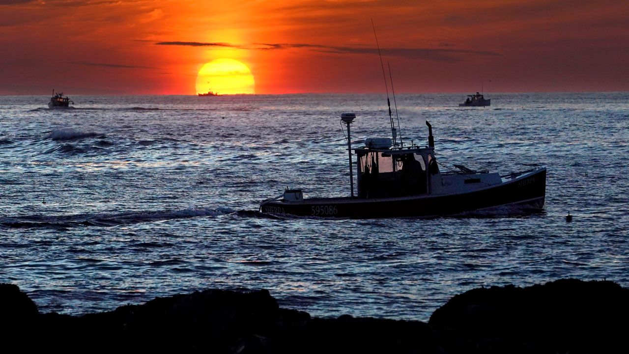 FILE - Lobster fishermen work at sunrise, Thursday, Sept. 8, 2022, off Kennebunkport, Maine. For years, regional regulators have been accused of undemocratic practices that favor large, industrial fishers but now several conservation groups are banding together to renew calls for a culture change. (AP Photo/Robert F. Bukaty, File)
