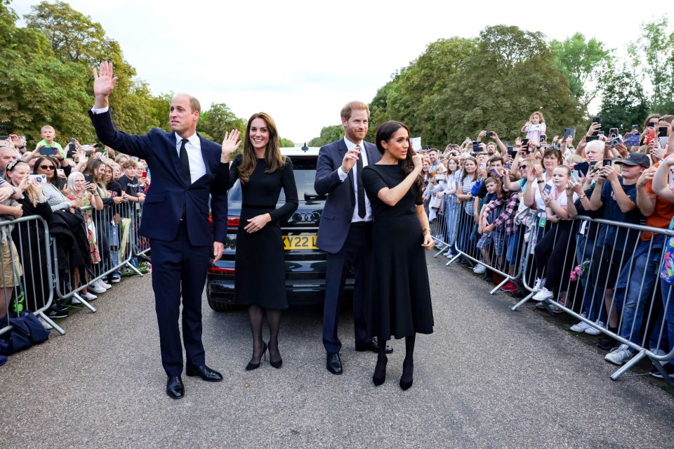 a group of people standing in front of an audi car