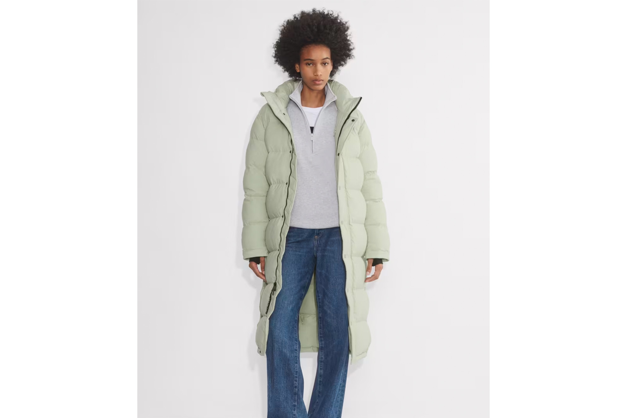 A model in a seafoam green coat