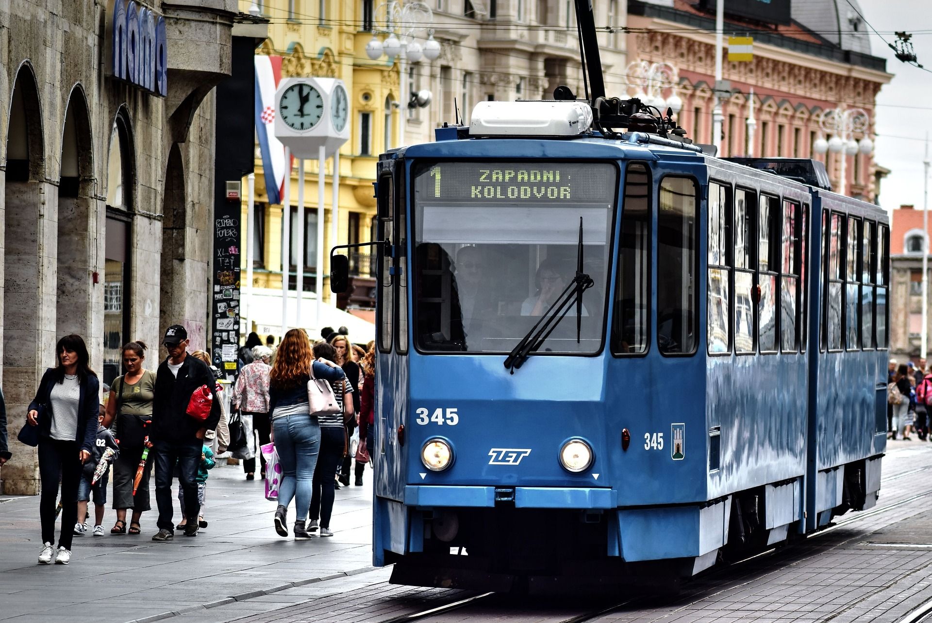 A blue tram passing through Zagreb, Croatia, Europe