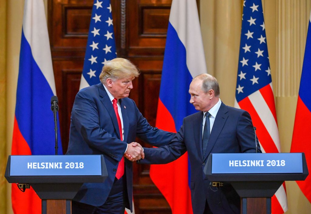 Donald Trump (L) and Russia's President Vladimir Putin shake hands before attending a joint press conference after a meeting at the Presidential Palace in Helsinki, on July 16, 2018.