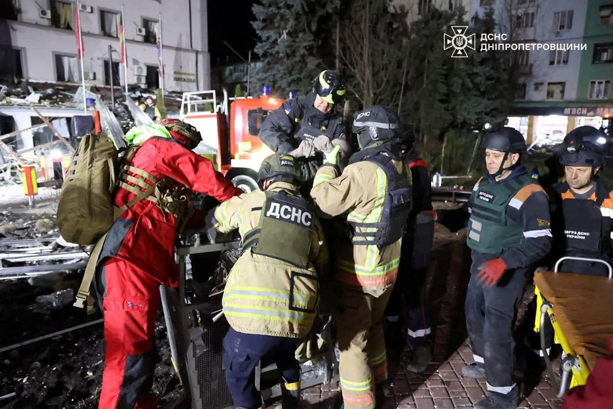 Rescuers carry a wounded person from a damaged hotel after a Russian missile strike in Kryvyi Rih, Ukraine.