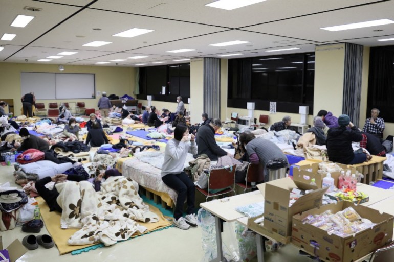 Residents who were evacuated due to the nearby wildfires stay overnight at a shelter in the city of Ofunato, Iwate Prefecture on February 27, 2025. At least one person has died in a wildfire that damaged more than 80 buildings and forced the evacuation of hundreds of residents in Japan, authorities said on February 27. (Photo by JIJI Press / AFP) / Japan OUT