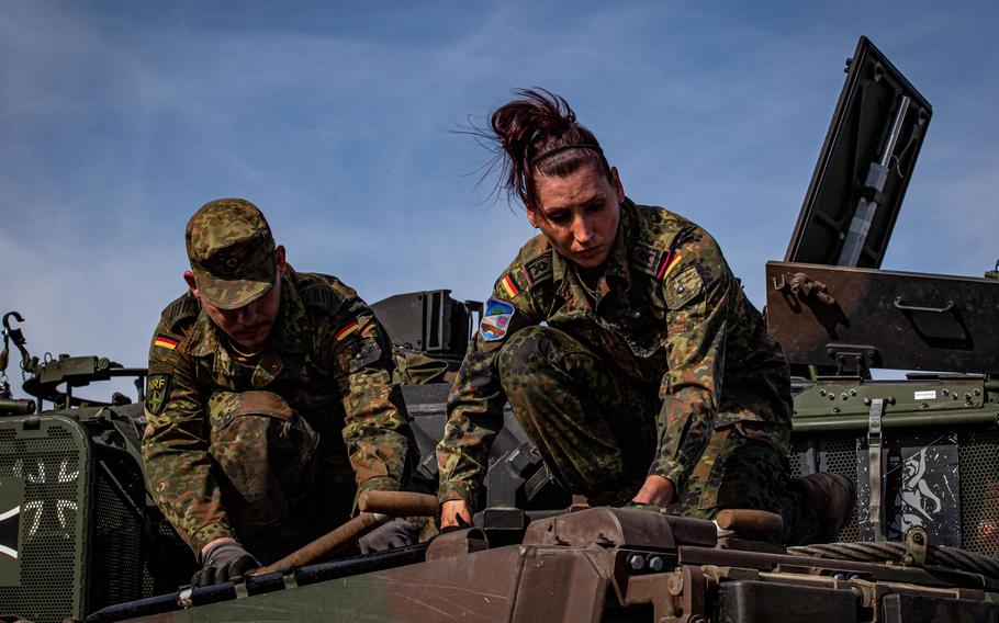 German soldiers prepare a Leopard 2 A7V battle tank for an exercise.
