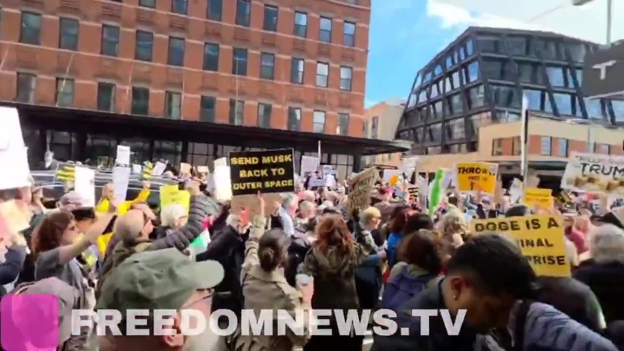 Crowd chants "Zelensky is a hero" outside of a Tesla dealership in Manhattan