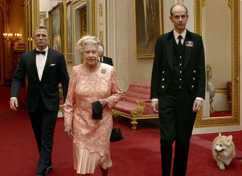 Screenshot of Queen Elizabeth II, James Bond, and a corgi walking through Buckingham Palace.