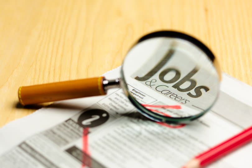 The classified jobs sections with a magnifying glass on top of it
