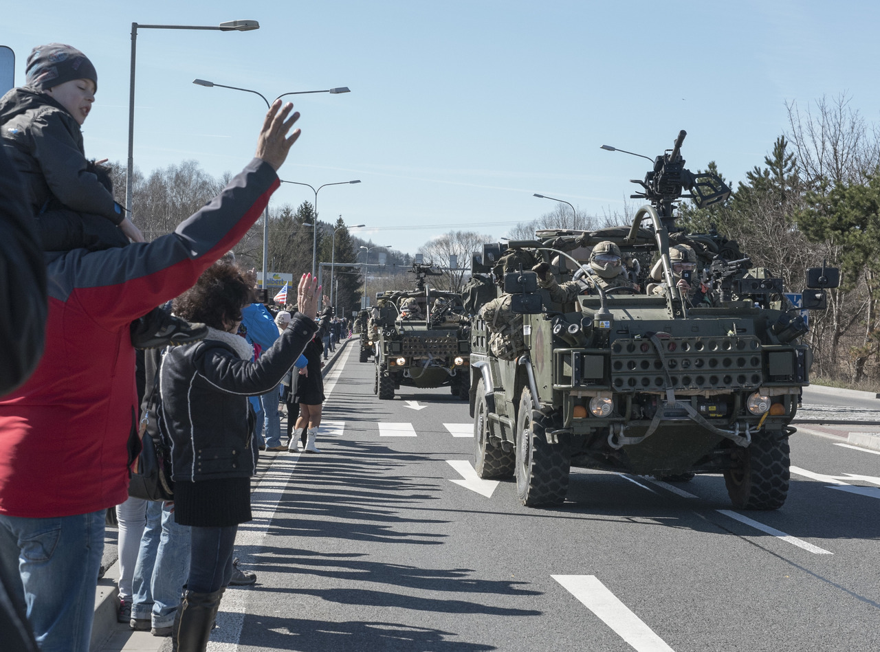 Polish citizens greet the Soldiers of Battle Group Poland as the convoy of tactical vehicles crosses the border from the Czech Republic into Poland March 26, 2017.