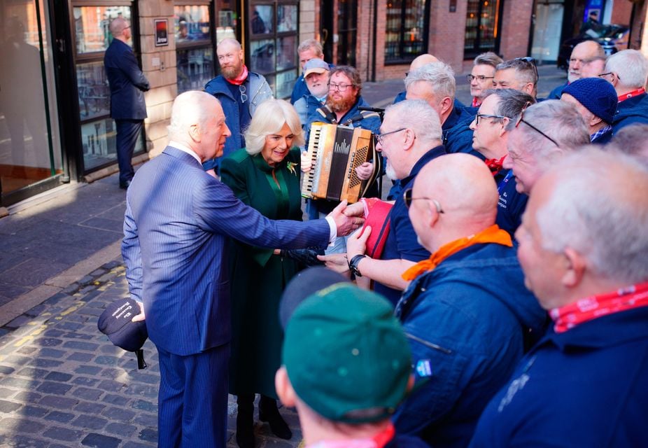 King Charles III and Queen Camilla speaks to the band during a visit to Commercial Court, Belfast. Ben Birchall/PA Wire