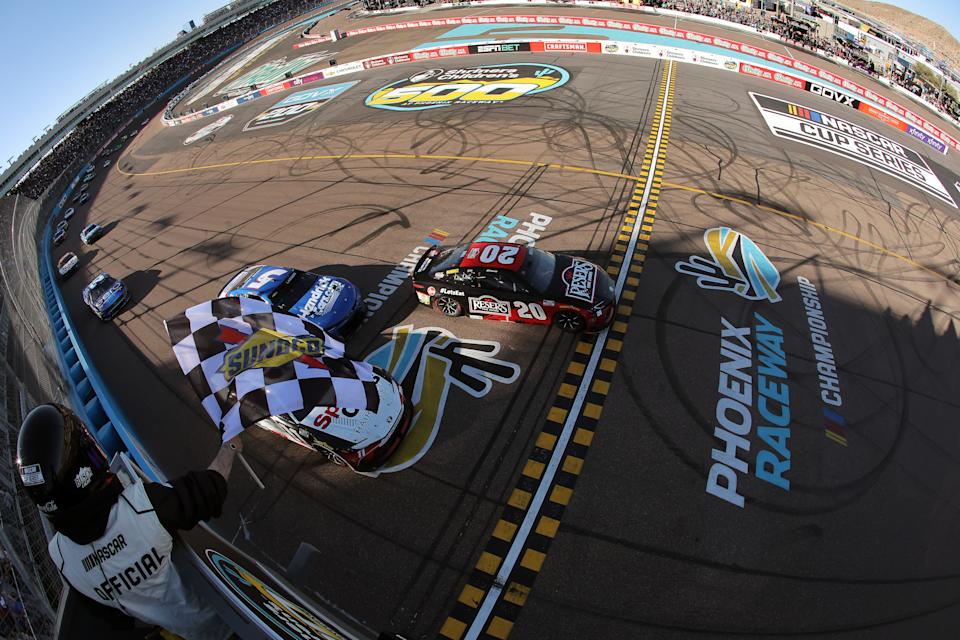 AVONDALE, ARIZONA - MARCH 09: Christopher Bell, driver of the #20 Reser's Fine Foods Toyota, takes the checkered flag to win the NASCAR Cup Series Shriners Children's 500 at Phoenix Raceway on March 09, 2025 in Avondale, Arizona. (Photo by Jonathan Bachman/Getty Images)