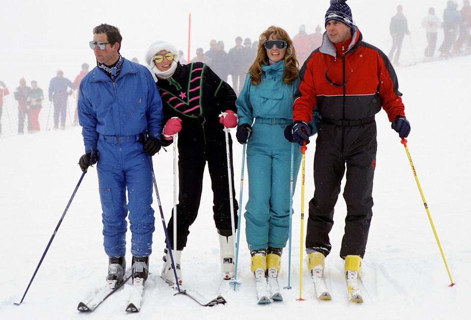 Prince Charles, Princess Diana, Sarah Ferguson and Prince Andrew standing with ski poles in the snow in 1987