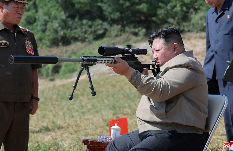 Kim Jong Un aiming a rifle at a North Korean army training base.