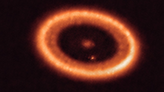 An orange fiery ring against a black background.
