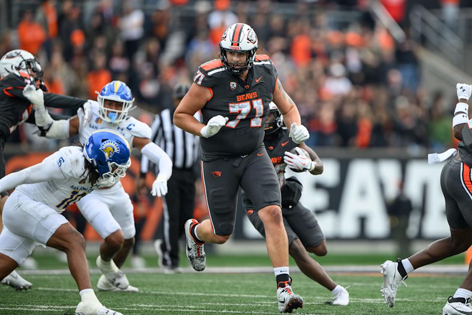 Nov 9, 2024; Corvallis, Oregon, USA; Oregon State Beavers offensive lineman Gerad Christian-Lichtenhan (71) pulls ahead of running back Salahadin Allah (26) during the second quarter against the San Jose State Spartans at Reser Stadium. Mandatory Credit: Craig Strobeck-Imagn Images
