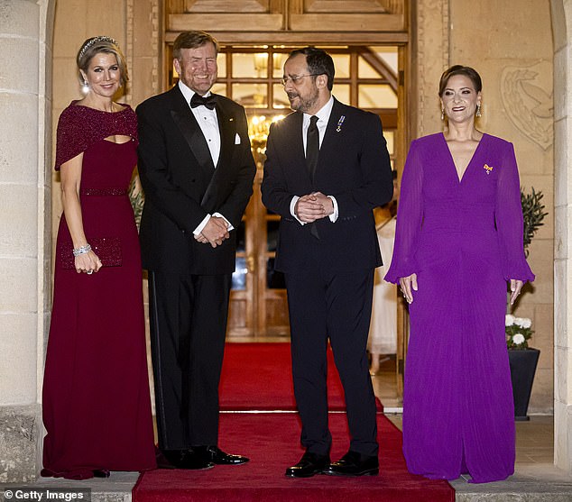 Philippa looked equally striking in a shocking purple gown with long sleeves and a deep V-neck