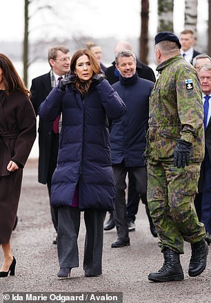 Mary added a long navy puffer jacket on top of her smart attire