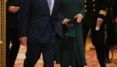 Britain's King Charles and Queen Camilla arrive with equerry Lieutenant Commander Will Thornton (R) and equerry Major Oliver 'Ollie' Plunket (L) to meet members of the The Military Wives Choirs, at Buckingham Palace in London on December 11, 2024