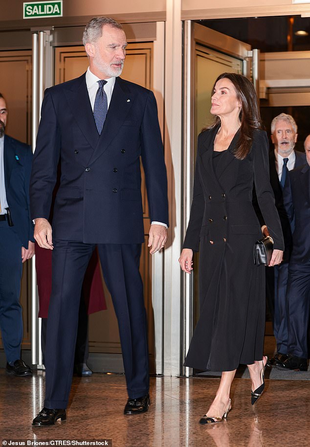 Letizia, a former news anchor, wore a double-breasted black coat dress with prominent gold buttons